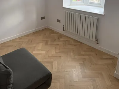 The finished living space with herringbone flooring