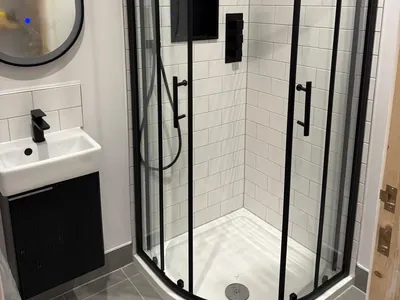 The new shower room with a quadrant enclosure and wall-hung vanity