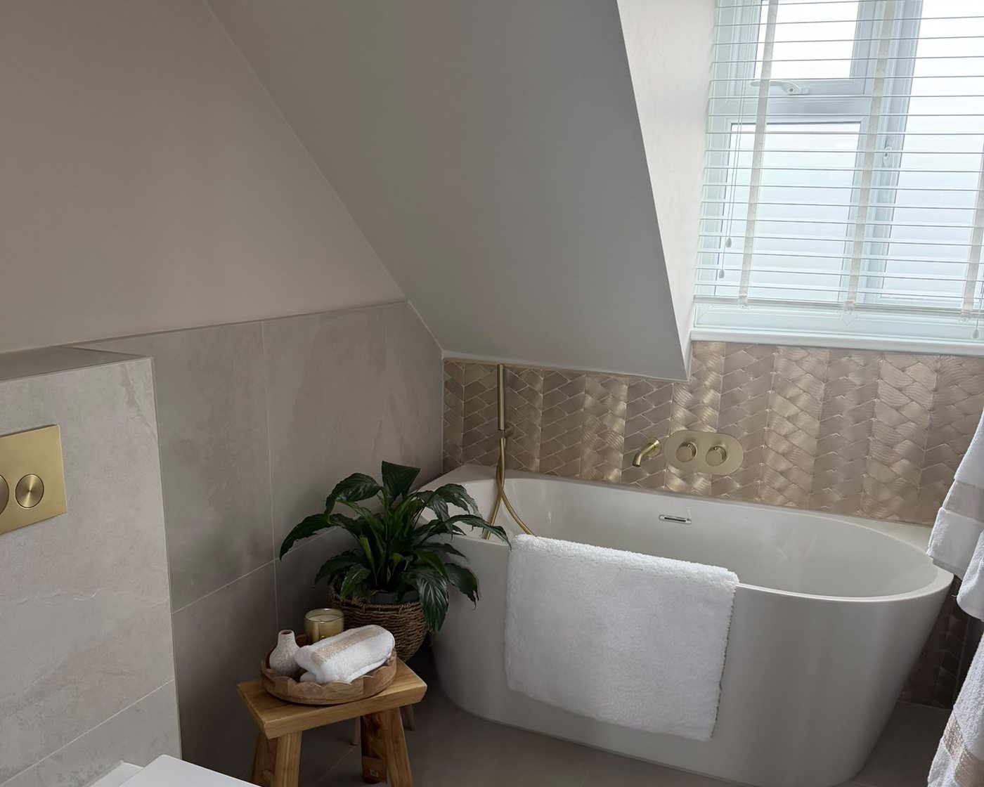 A finished bathroom by Abbotts Build Hub, with a freestanding bath and brass fittings